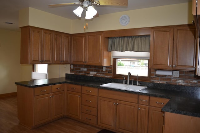 3127 Jo Ann Dr, Joliet, IL 60431 - kitchen with a sink, a peninsula, brown cabinets, and tasteful backsplash