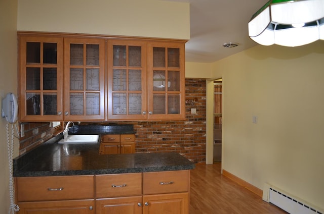3127 Jo Ann Dr, Joliet, IL 60431 - kitchen with baseboard heating, a sink, light wood-style flooring, and glass insert cabinets