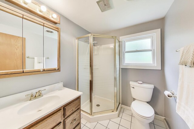 3205 Meadow Dr, Rolling Meadows, IL 60008 - bathroom featuring toilet, vanity, a stall shower, tile patterned flooring, and baseboards