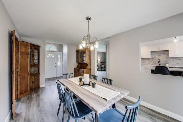 3205 Meadow Dr, Rolling Meadows, IL 60008 - dining area featuring wood finished floors, baseboards, and a chandelier
