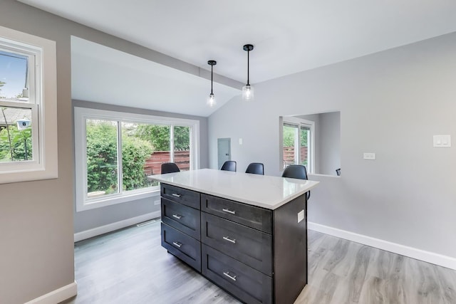 3205 Meadow Dr, Rolling Meadows, IL 60008 - kitchen featuring light wood-style floors, baseboards, plenty of natural light, vaulted ceiling, and light countertops