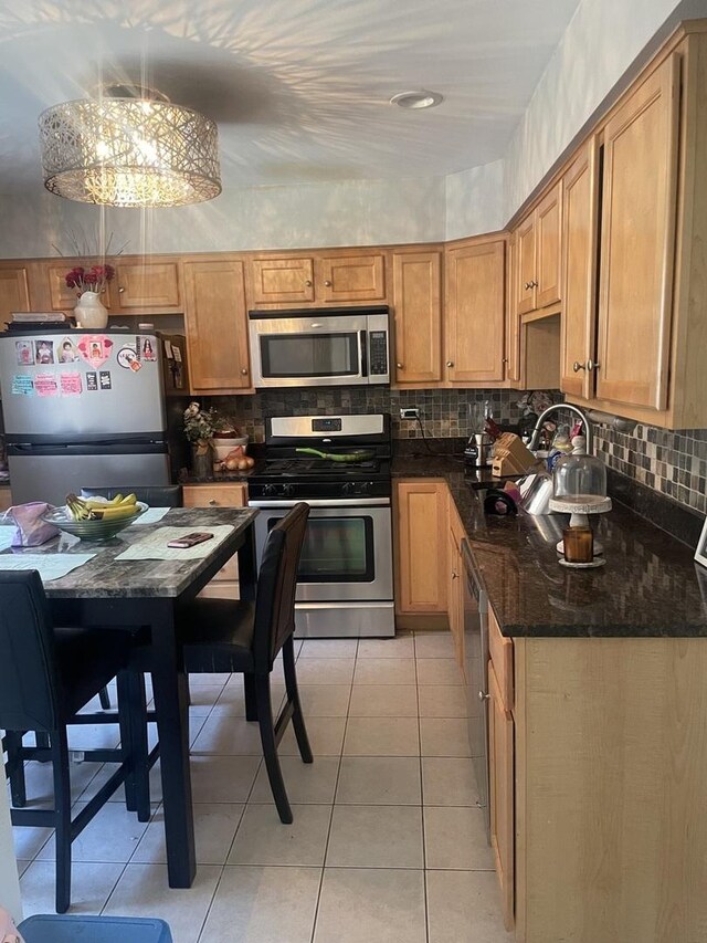 549 E Lincoln St Unit 549, Mount Prospect, IL 60056 - kitchen with stainless steel appliances, backsplash, light tile patterned flooring, and a sink