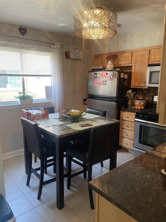 549 E Lincoln St Unit 549, Mount Prospect, IL 60056 - dining space featuring light tile patterned floors, baseboards, and a chandelier