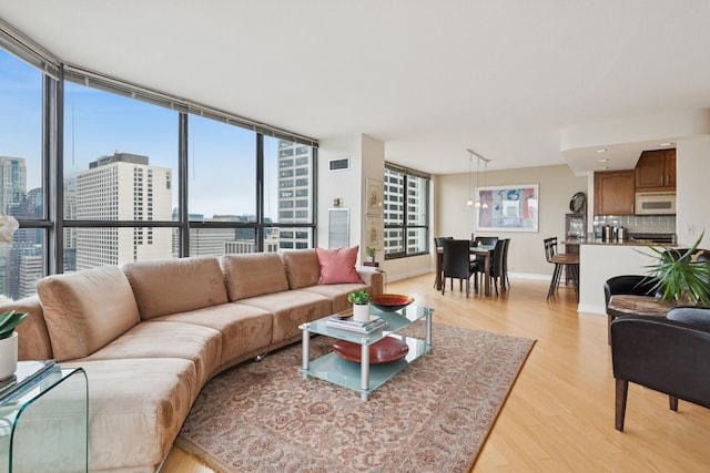 405 N Wabash Ave Unit 3103, Chicago, IL 60611 - living room featuring light wood-style floors, a view of city, and baseboards