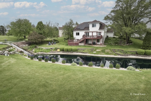 2012 Spring Creek Ln, Mchenry, IL 60050 - back of house featuring a deck with water view, stairway, solar panels, and a lawn
