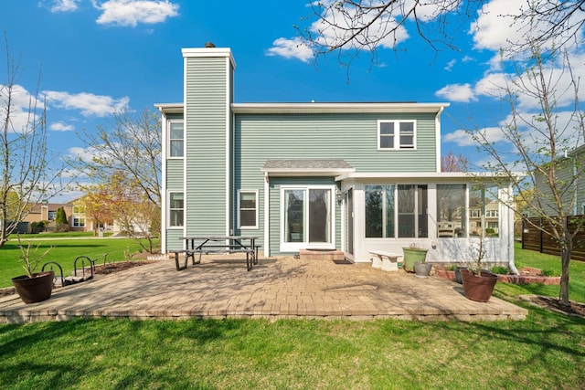 1282 Berkshire Ln, Grayslake, IL 60030 - rear view of property with a sunroom, a patio, a chimney, and a yard