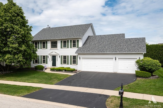 3365 Charlemaine Dr, Aurora, IL 60504 - colonial home featuring an attached garage, driveway, a front lawn, and roof with shingles