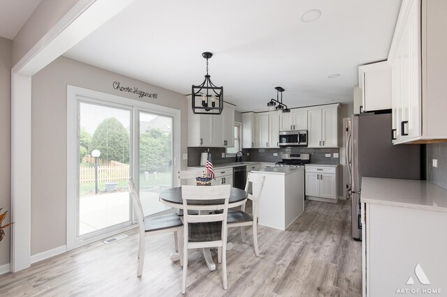 3365 Charlemaine Dr, Aurora, IL 60504 - kitchen featuring appliances with stainless steel finishes, tasteful backsplash, a chandelier, and a kitchen island