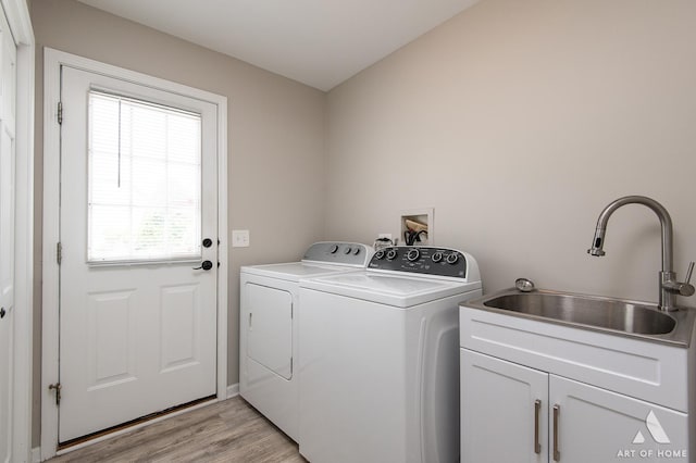 3365 Charlemaine Dr, Aurora, IL 60504 - laundry area featuring washing machine and dryer, cabinet space, and light wood-style floors