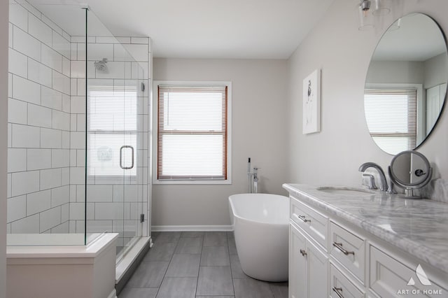 3365 Charlemaine Dr, Aurora, IL 60504 - full bath featuring a shower stall, vanity, a soaking tub, tile patterned floors, and baseboards