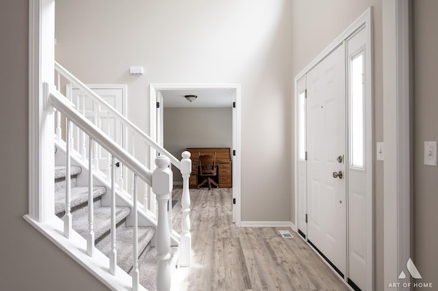 3365 Charlemaine Dr, Aurora, IL 60504 - foyer featuring stairway, light wood-style floors, and baseboards