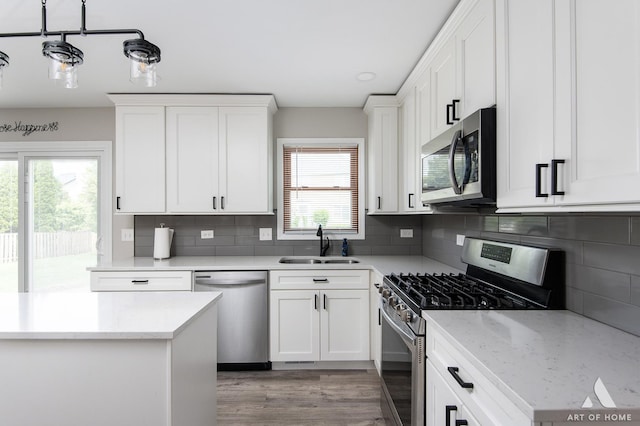 3365 Charlemaine Dr, Aurora, IL 60504 - kitchen featuring appliances with stainless steel finishes, a sink, white cabinets, and tasteful backsplash