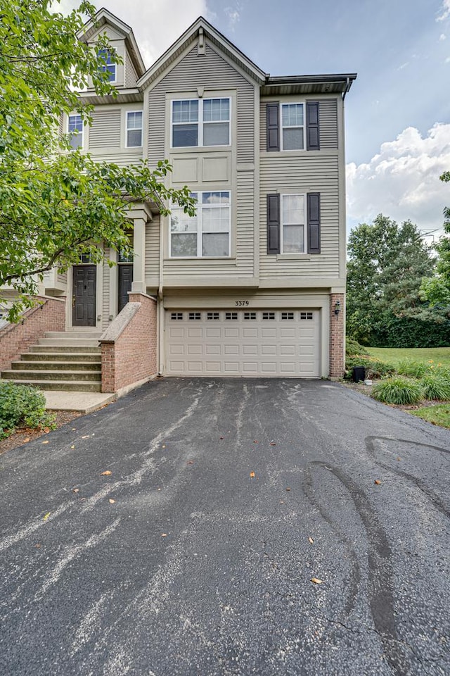 3379 Kentshire Cir, Aurora, IL 60504 - view of front of house with an attached garage, brick siding, and driveway