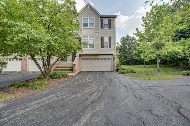 3379 Kentshire Cir, Aurora, IL 60504 - view of front of house featuring asphalt driveway, a garage, brick siding, and a front yard