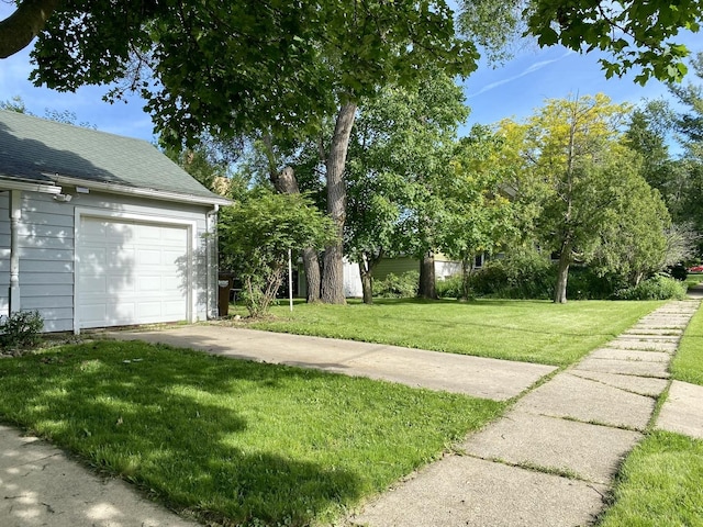 106 Dewey St, Harvard, IL 60033 - view of grassy yard with a garage and driveway