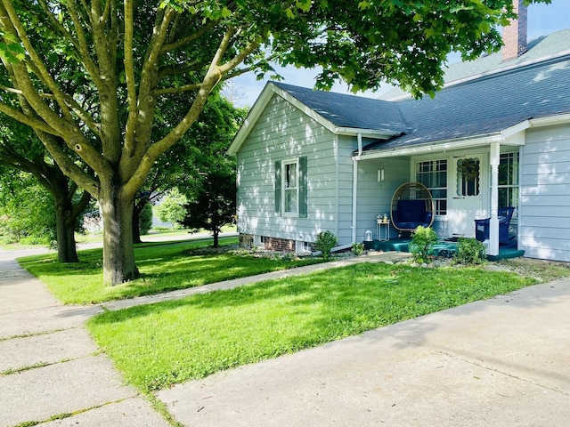106 Dewey St, Harvard, IL 60033 - view of property exterior featuring a lawn, roof with shingles, and a chimney