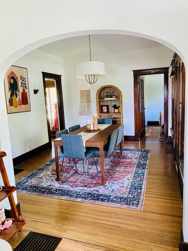 106 Dewey St, Harvard, IL 60033 - dining space with arched walkways, wood finished floors, and baseboards