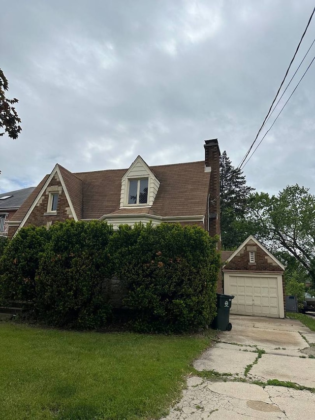 402 N NW Hwy, Park Ridge, IL 60068 - view of front facade with concrete driveway, a chimney, a front lawn, and a detached garage