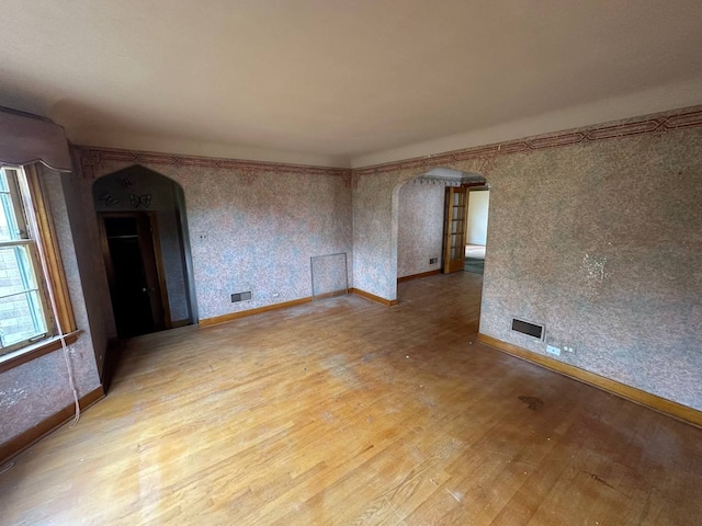 402 N NW Hwy, Park Ridge, IL 60068 - spare room with arched walkways, wood finished floors, and baseboards
