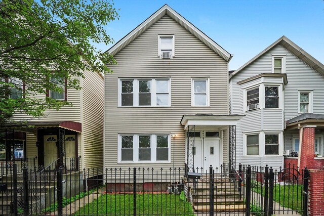 5014 S Paulina St, Chicago, IL 60609 - view of front of property with a fenced front yard, a gate, and cooling unit