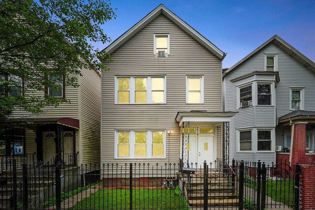 5014 S Paulina St, Chicago, IL 60609 - view of front of home with a fenced front yard, a gate, and cooling unit