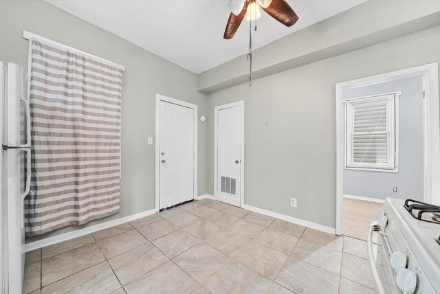 5014 S Paulina St, Chicago, IL 60609 - unfurnished dining area with light tile patterned floors, ceiling fan, and baseboards