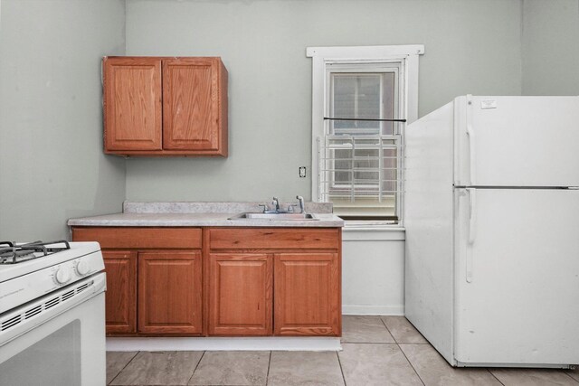 5014 S Paulina St, Chicago, IL 60609 - kitchen featuring white appliances, a sink, light countertops, brown cabinetry, and light tile patterned floors
