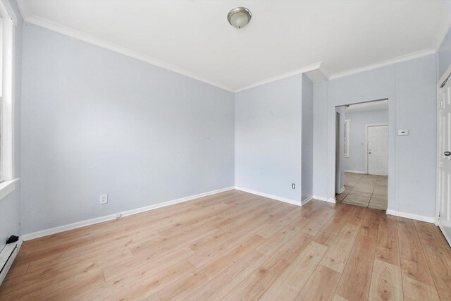 5014 S Paulina St, Chicago, IL 60609 - empty room with ornamental molding, wood finished floors, a baseboard radiator, and baseboards