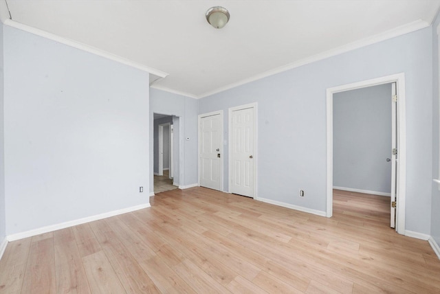 5014 S Paulina St, Chicago, IL 60609 - unfurnished bedroom with crown molding, light wood-style floors, baseboards, and multiple closets