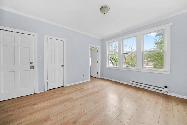 5014 S Paulina St, Chicago, IL 60609 - unfurnished bedroom featuring baseboard heating, ornamental molding, light wood-style floors, and baseboards
