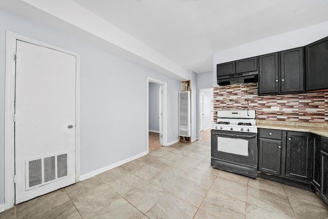 5014 S Paulina St, Chicago, IL 60609 - kitchen with range with gas cooktop, under cabinet range hood, decorative backsplash, and dark cabinets