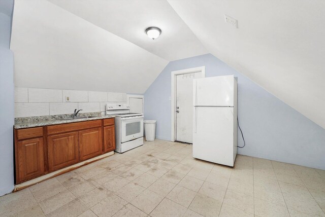 5014 S Paulina St, Chicago, IL 60609 - kitchen featuring white appliances, lofted ceiling, brown cabinetry, a sink, and light flooring