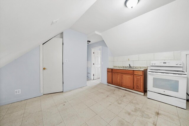 5014 S Paulina St, Chicago, IL 60609 - kitchen with electric stove, vaulted ceiling, brown cabinetry, a sink, and light stone counters