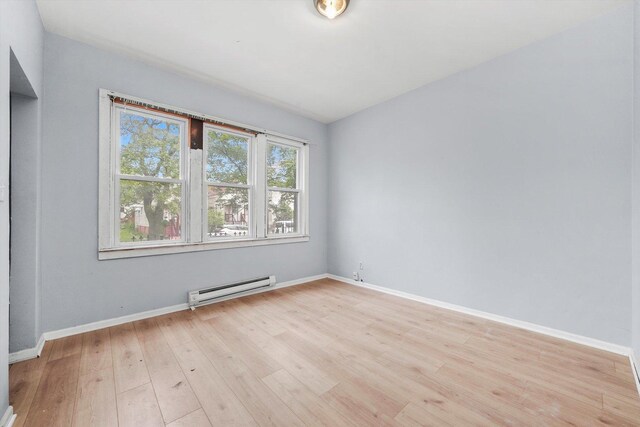 5014 S Paulina St, Chicago, IL 60609 - unfurnished room featuring baseboard heating, light wood finished floors, and baseboards