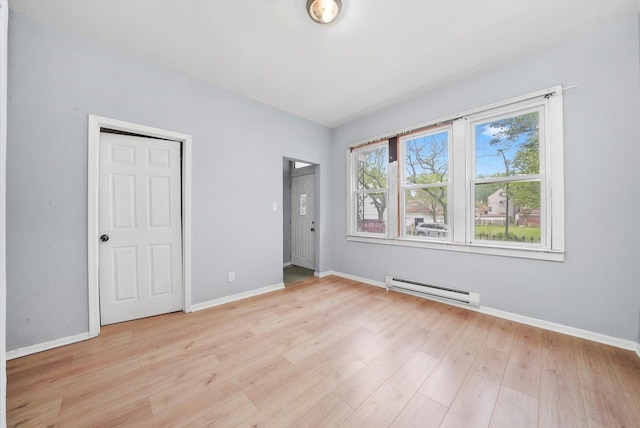 5014 S Paulina St, Chicago, IL 60609 - unfurnished bedroom featuring a baseboard radiator, baseboards, and light wood-type flooring