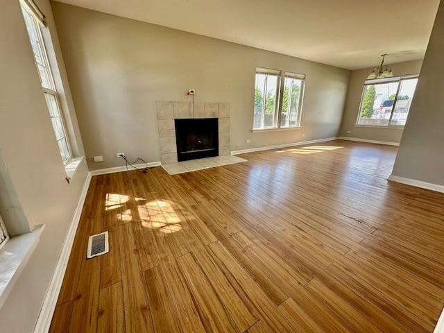 1458 Woodland Dr, South Elgin, IL 60177 - unfurnished living room featuring wood finished floors, baseboards, and a fireplace