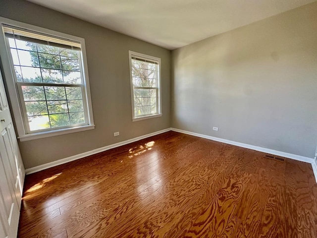 1458 Woodland Dr, South Elgin, IL 60177 - unfurnished room featuring wood finished floors, healthy amount of natural light, and baseboards