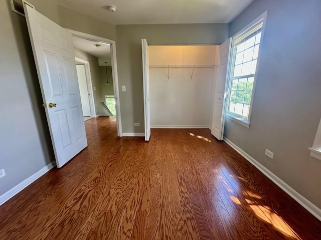 1458 Woodland Dr, South Elgin, IL 60177 - unfurnished bedroom featuring dark wood finished floors, a closet, and baseboards
