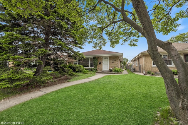 5513 Mulford St, Skokie, IL 60077 - view of front of house featuring a front yard and brick siding