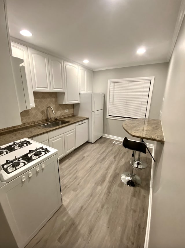 501 E Prospect Ave Unit 1F, Mount Prospect, IL 60056 - kitchen featuring white appliances, white cabinets, a sink, light wood finished floors, and backsplash