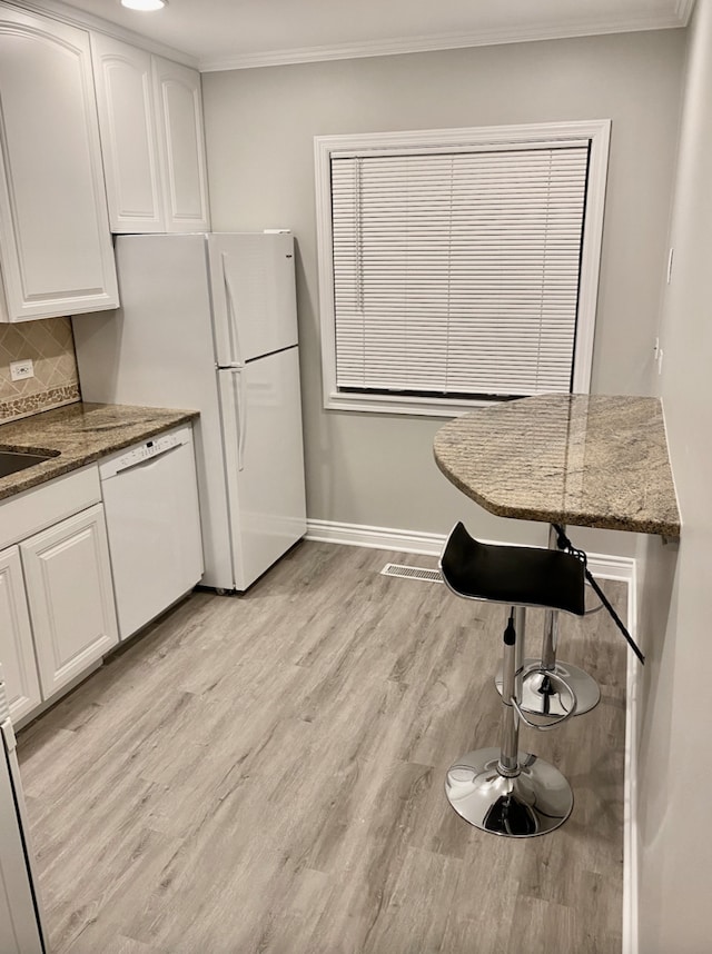 501 E Prospect Ave Unit 1F, Mount Prospect, IL 60056 - kitchen featuring dishwasher, white cabinetry, light wood-style floors, crown molding, and decorative backsplash
