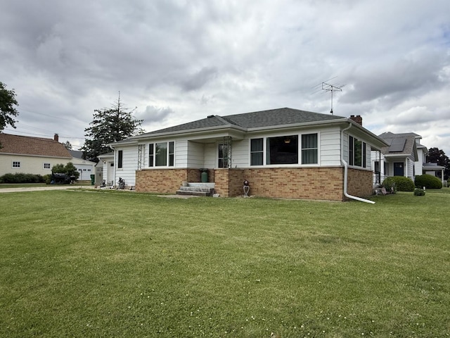 612 S 1st Ave, Forreston, IL 61030 - view of front of property featuring brick siding, a front yard, a chimney, and a garage