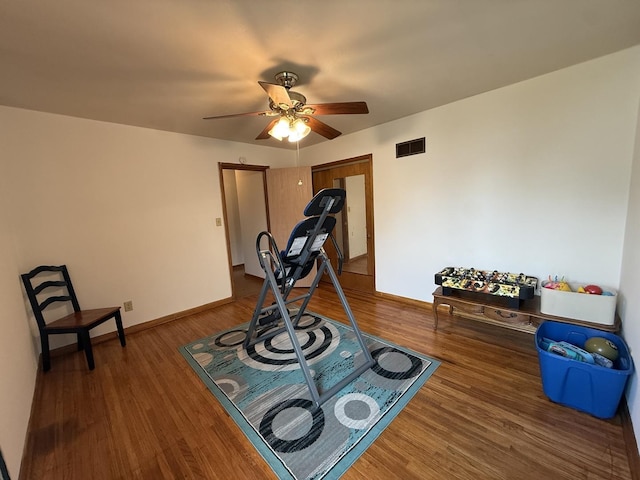 612 S 1st Ave, Forreston, IL 61030 - exercise room with wood finished floors, ceiling fan, and baseboards