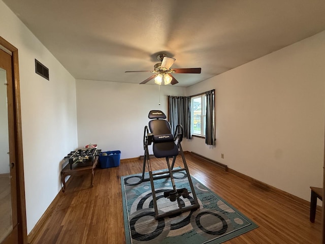 612 S 1st Ave, Forreston, IL 61030 - exercise room featuring dark wood finished floors, ceiling fan, and baseboards