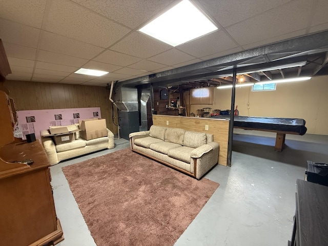 612 S 1st Ave, Forreston, IL 61030 - living room featuring finished concrete flooring, a drop ceiling, heating unit, wood walls, and pool table