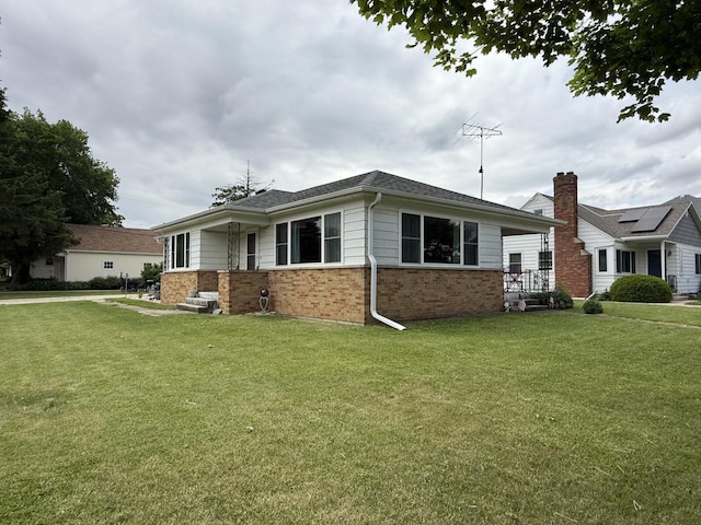 612 S 1st Ave, Forreston, IL 61030 - view of home's exterior with brick siding and a lawn