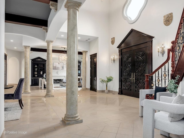 11315 77th St, Burr Ridge, IL 60527 - entryway with ornate columns, a towering ceiling, stairway, arched walkways, and recessed lighting