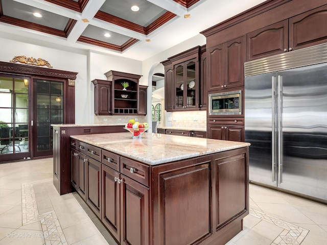 11315 77th St, Burr Ridge, IL 60527 - kitchen featuring built in appliances, open shelves, inlaid floor details, light tile patterned flooring, and beamed ceiling