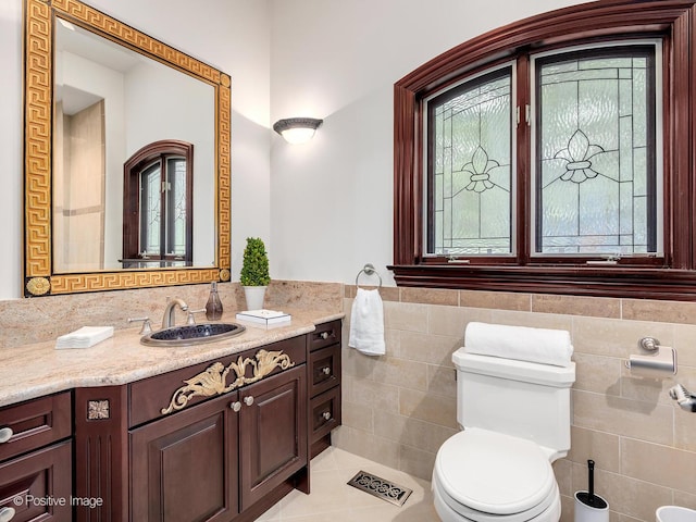 11315 77th St, Burr Ridge, IL 60527 - bathroom featuring tile walls, vanity, plenty of natural light, tile patterned floors, and wainscoting