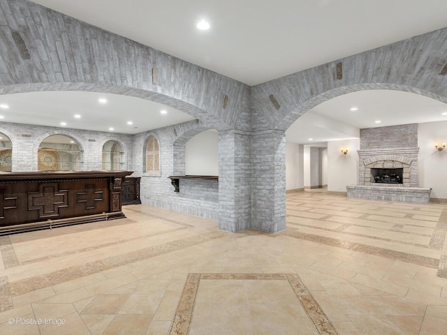 11315 77th St, Burr Ridge, IL 60527 - unfurnished living room featuring inlaid floor details, recessed lighting, arched walkways, and a large fireplace